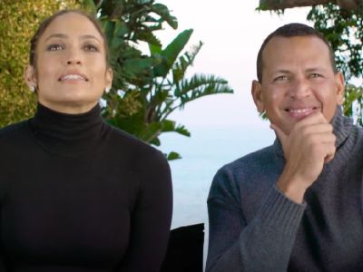 Jennifer Lopez is wearing a black top whereas, Alex Rodriguez is wearing a grey turtleneck. 